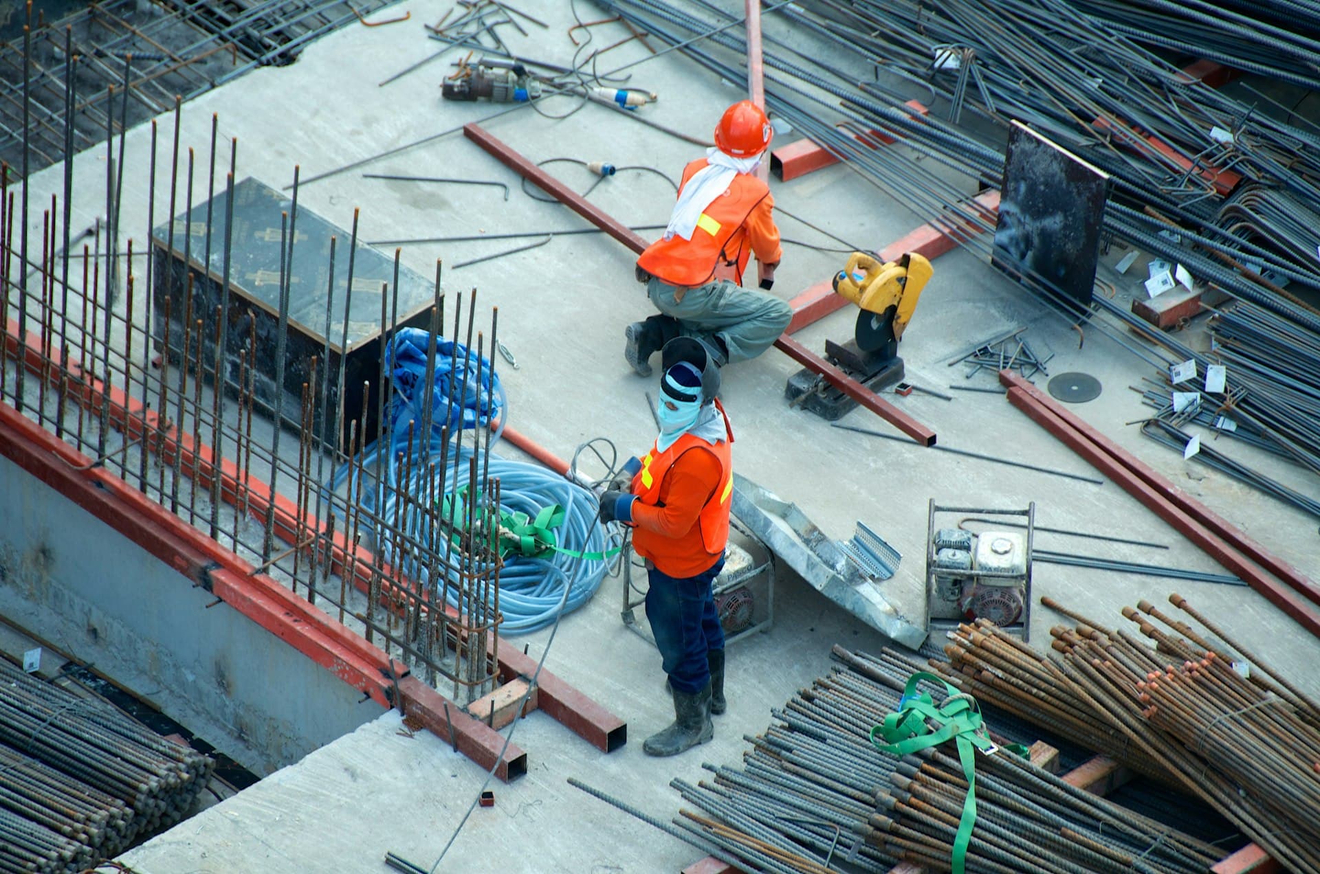 Construction site with cranes against a cloudy sky